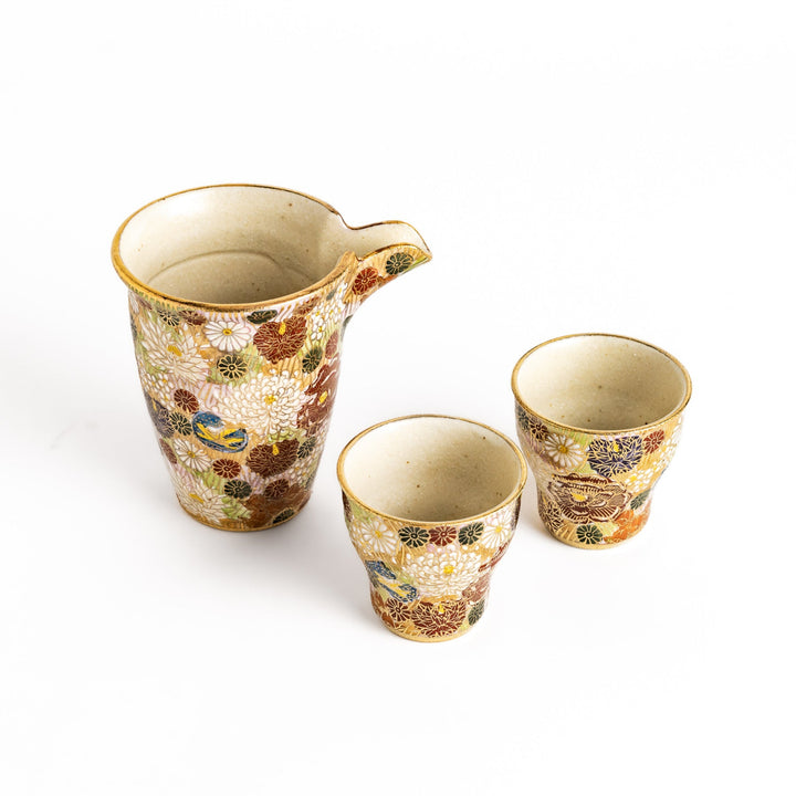 Elegant sake set with a beautiful floral pattern in gold and pastel colors, featuring a sake pitcher and two matching cups, perfect for serving and enjoying sake in style.