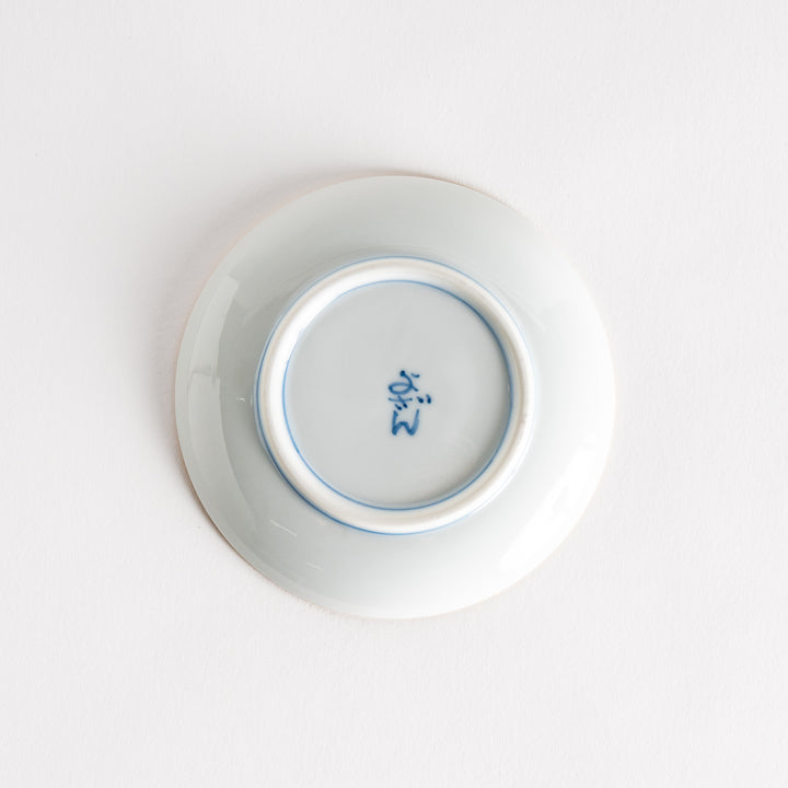 Bottom view of the sauce dish showing the blue signature markings and smooth porcelain finish.