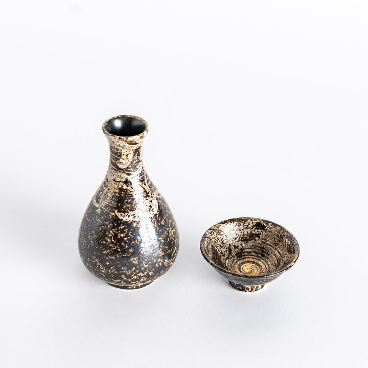 Gold rustic finish sake flask paired with a matching sake cup, both featuring intricate patterns and a unique textured surface.