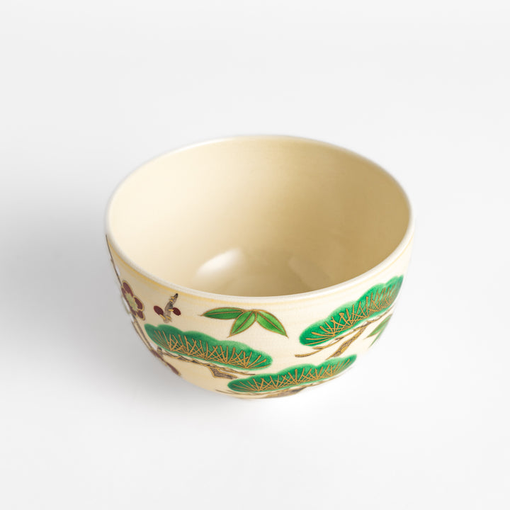 Golden Pine, Bamboo, and Plum Matcha Bowl featuring intricate green, gold, and red designs, perfect for enjoying matcha with elegance.