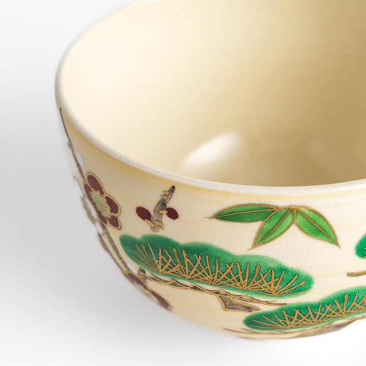 Golden Pine, Bamboo, and Plum Matcha Bowl featuring intricate green, gold, and red designs, perfect for enjoying matcha with elegance.