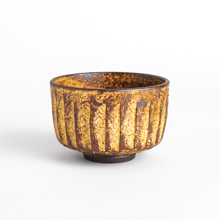 Rustic ceramic Matcha bowl with a textured, almost cracked glaze, perfect for a traditional Japanese tea ceremony.