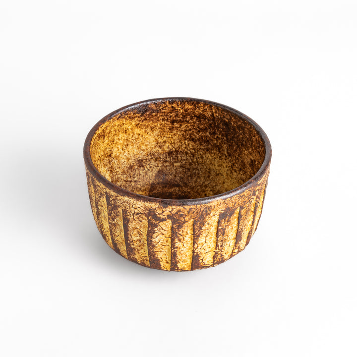 Rustic ceramic Matcha bowl with a textured, almost cracked glaze, perfect for a traditional Japanese tea ceremony.