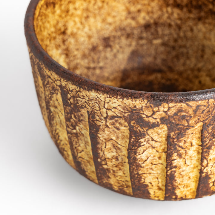 Rustic ceramic Matcha bowl with a textured, almost cracked glaze, perfect for a traditional Japanese tea ceremony.