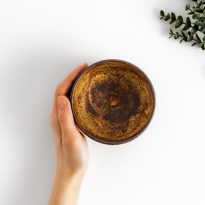 Rustic ceramic Matcha bowl with a textured, almost cracked glaze, perfect for a traditional Japanese tea ceremony.