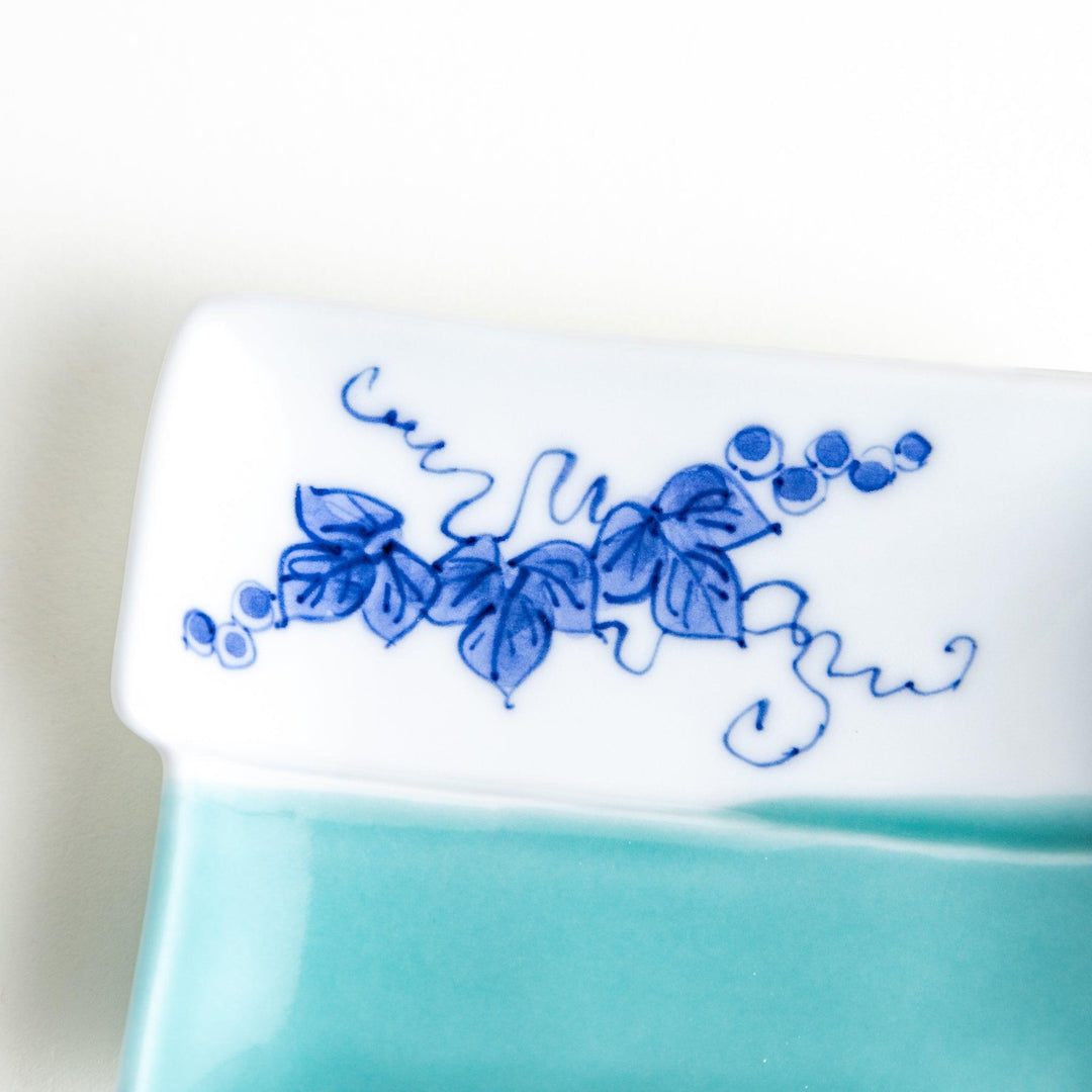 Rectangular plate with a blue floral grapevine design.