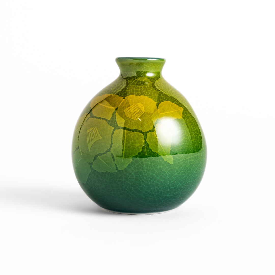 Green ceramic sake carafe with a subtle leaf pattern and a unique crackled glaze, perfect for serving sake in style.