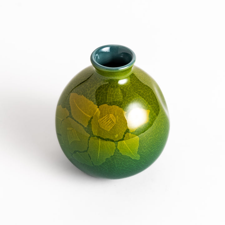 Green ceramic sake carafe with a subtle leaf pattern and a unique crackled glaze, perfect for serving sake in style.