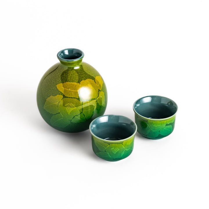 Green ceramic sake set with a subtle leaf pattern, including a sake bottle and two cups, perfect for enjoying traditional Japanese sake.