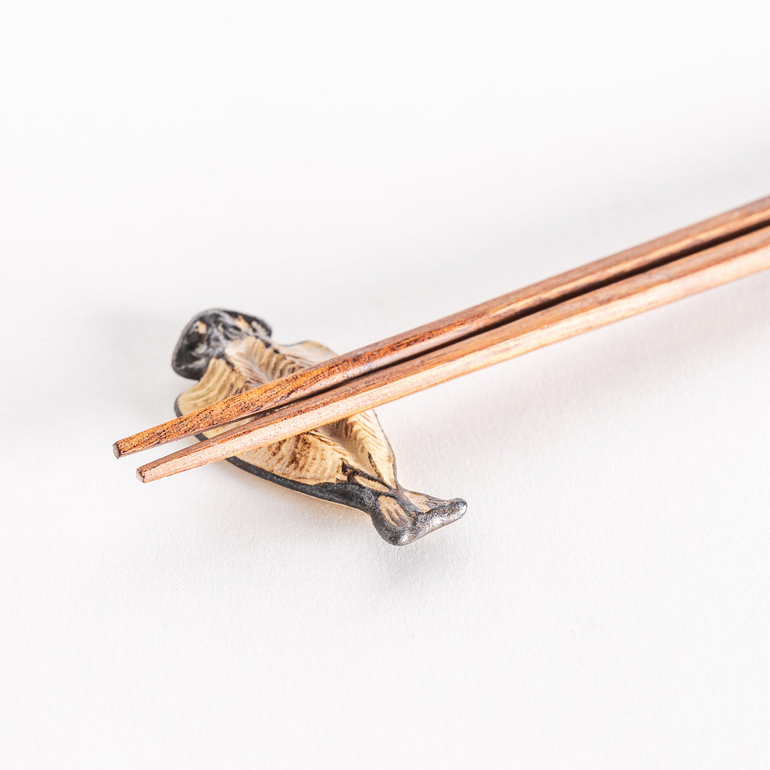 Close-up of chopsticks resting on the grilled horse mackerel chopsticks rest.