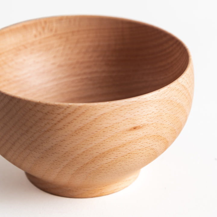 Slightly angled view of a handcrafted beech wood bowl, featuring a subtle yet attractive design for everyday use.