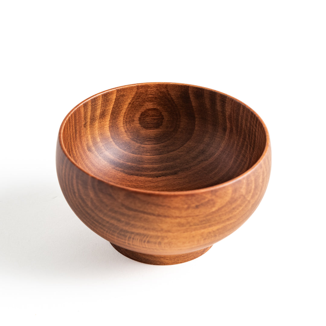 A close-up of the handcrafted beechwood bowl, emphasizing its deep, round shape and rich wood color.