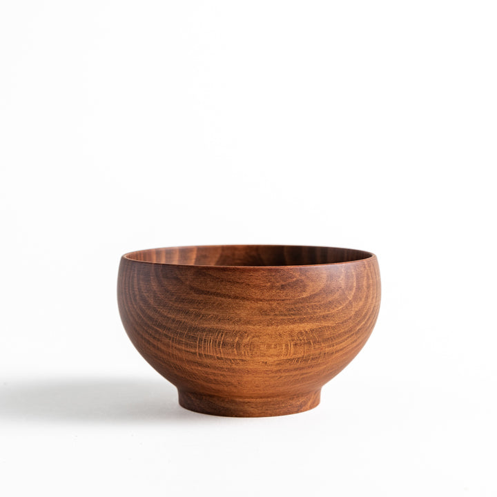 A smooth wooden bowl crafted from beech, showcasing natural grains. Perfect for serving a variety of dishes.