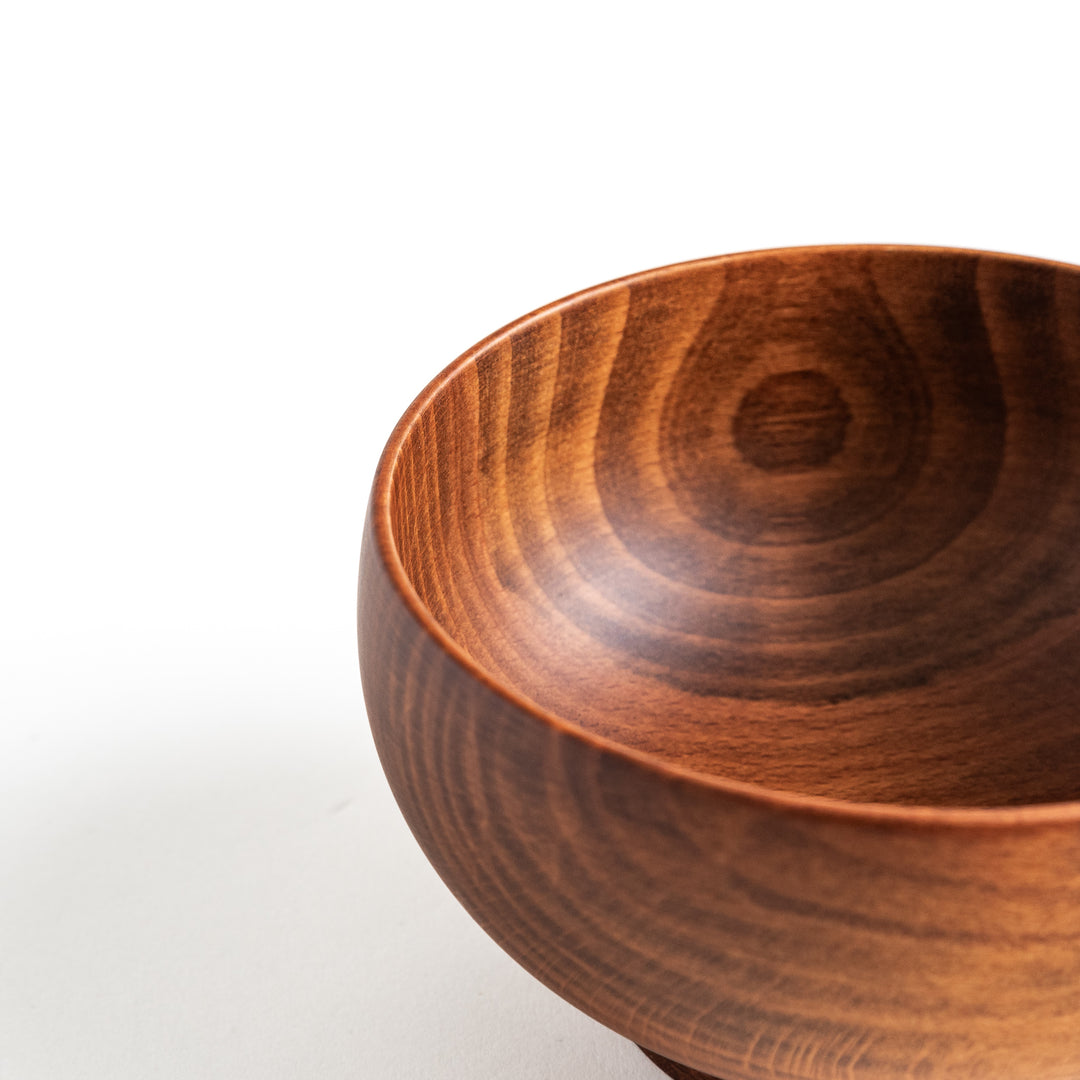 Another perspective of the handcrafted beechwood bowl, capturing its elegant silhouette and craftsmanship.