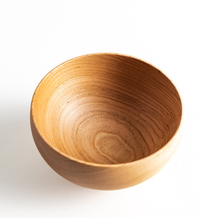 Close-up of the cherry wood bowl's interior, showing the fine wood grain and spacious design. Ideal for serving soups or small dishes.