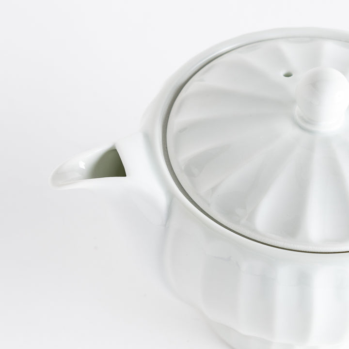 Close-up of the teapot's lid and spout, showcasing the refined craftsmanship and elegant silhouette.