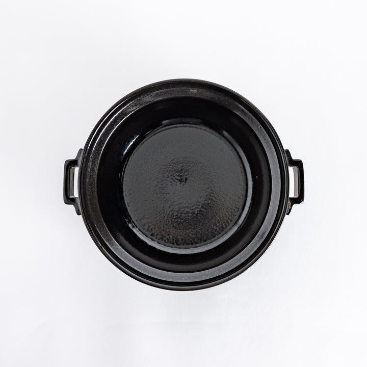 Top-down view of the black donabe pot without its lid, showing its smooth, spacious interior.