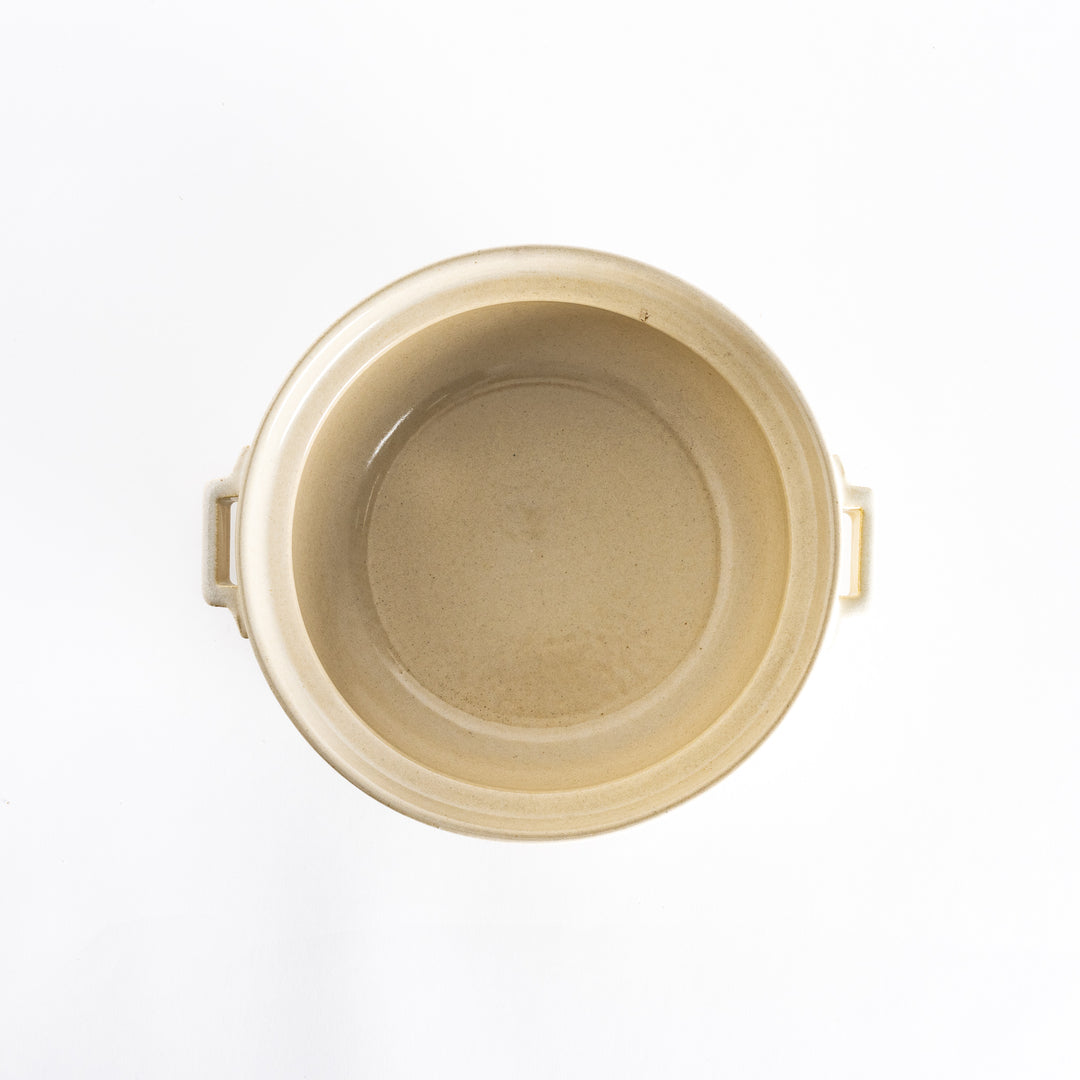 Top-down view of the off-white donabe pot without its lid, showing its spacious and smooth interior.