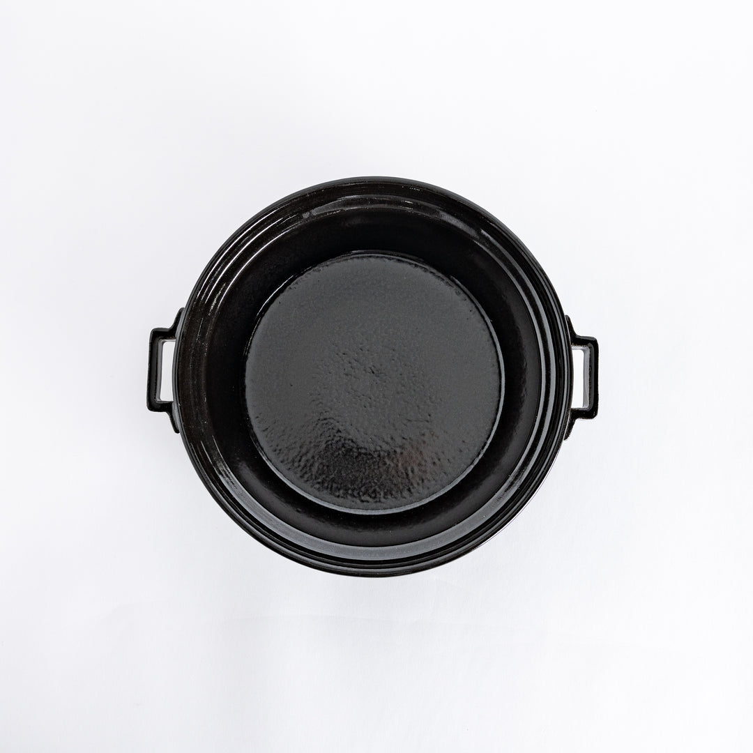 Top-down view of the black donabe pot without its lid, showing its smooth, spacious interior.