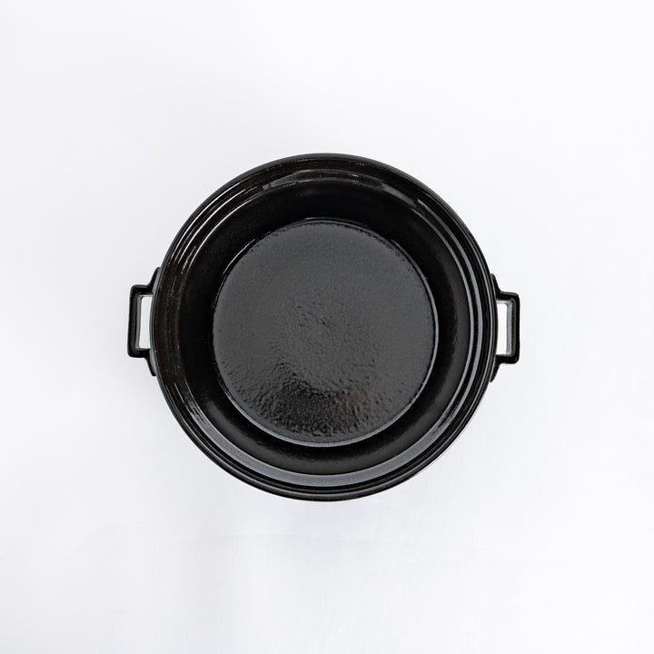 Top-down view of the black donabe pot without its lid, showing its smooth, spacious interior.