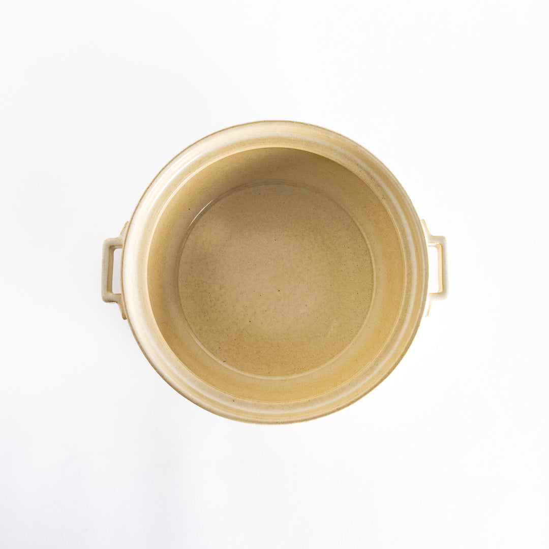 Top-down view of the off-white donabe pot without its lid, showing its spacious and smooth interior.