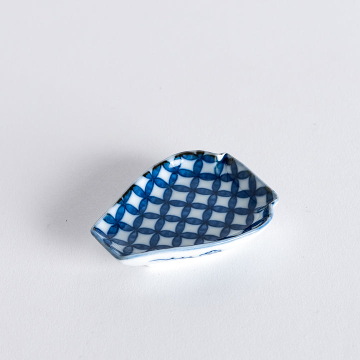 A small blue geometric-patterned sauce dish shaped like a vase, featuring a distinct, elegant design.