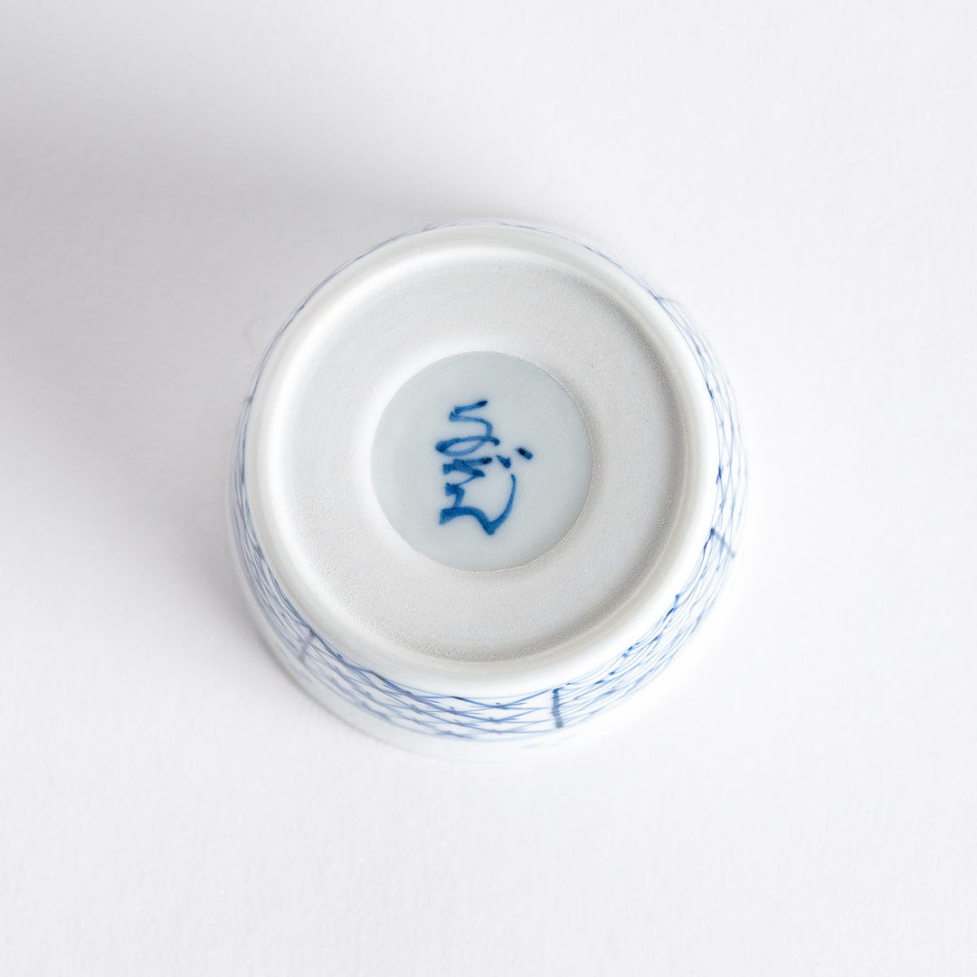 A small white bowl adorned with a delicate blue wave pattern around the edge, perfect for sauces or small sides.