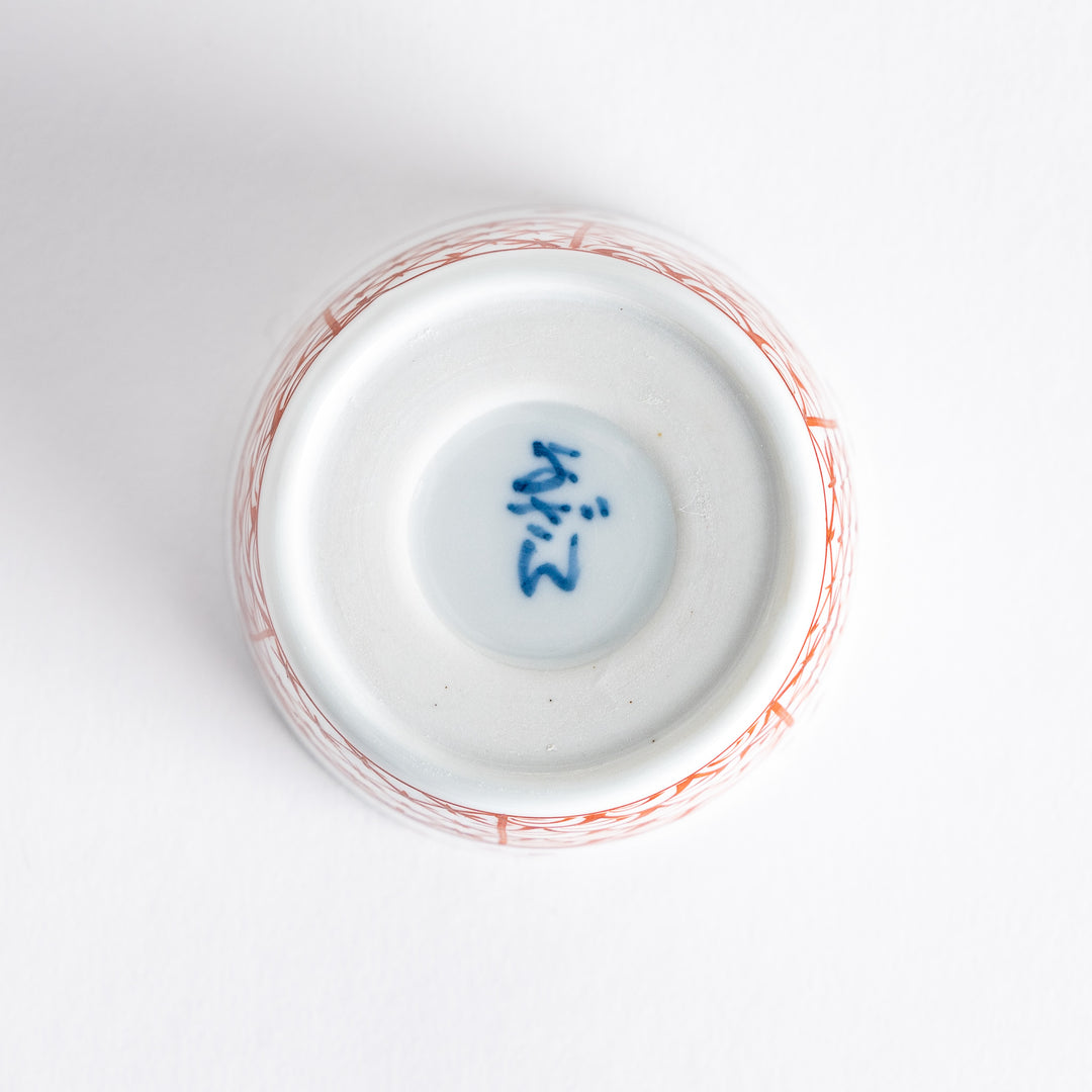 A small white bowl adorned with a delicate blue wave pattern around the edge, perfect for sauces or small sides.