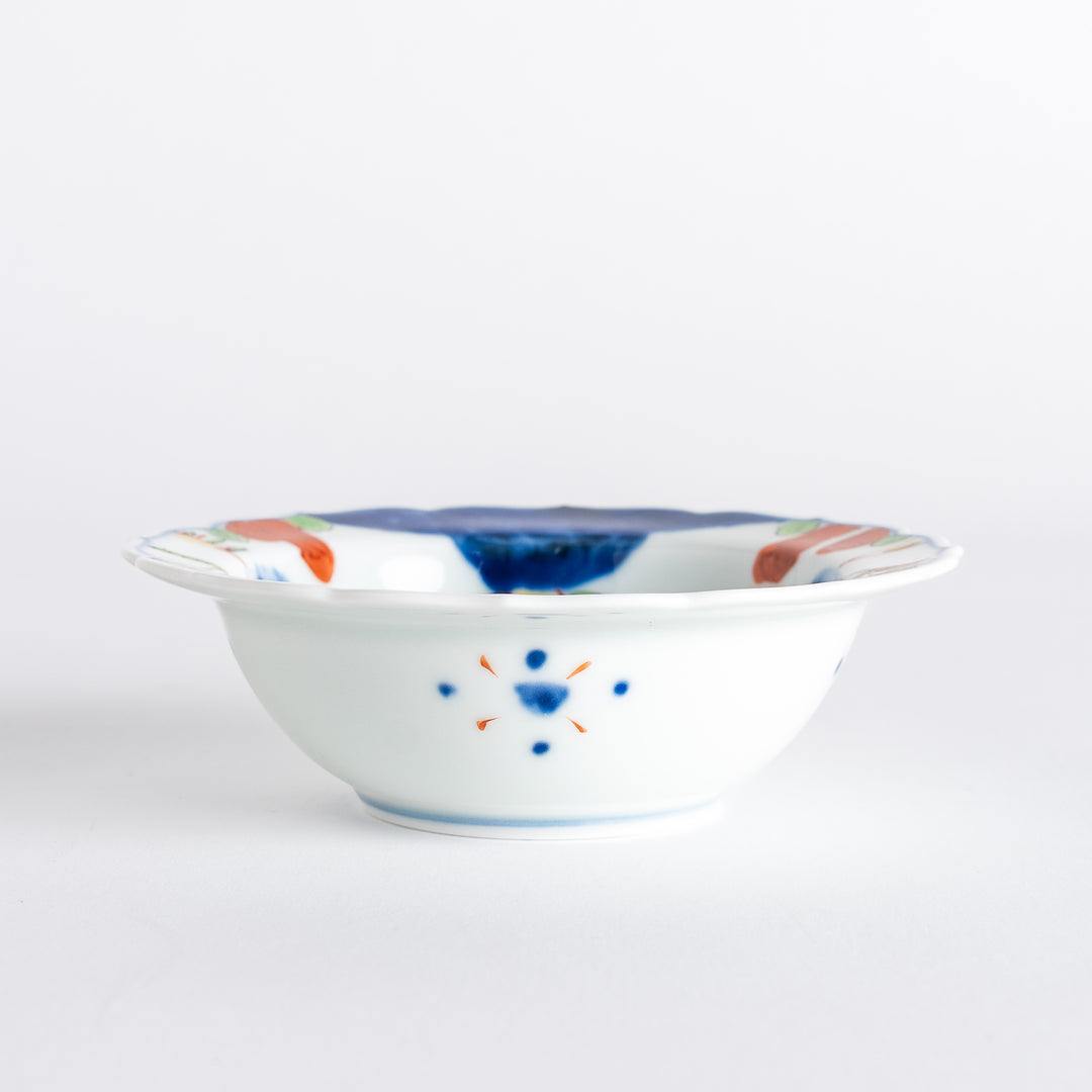 A small dessert bowl featuring colorful designs, including a galloping horse and abstract landscape motifs.