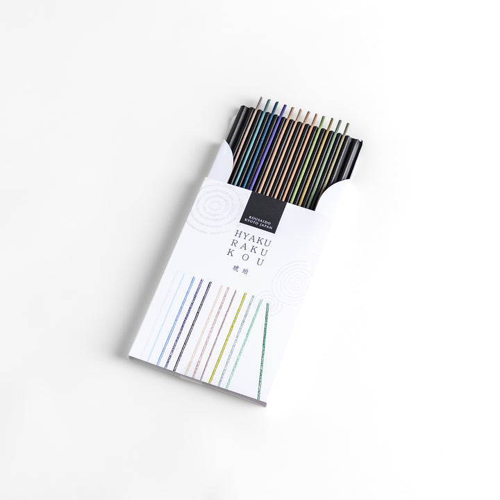 Incense set featuring a variety of colorful sticks elegantly packaged in a sleek white box with subtle circular patterns, offering a refined selection of rich and soothing aromas.