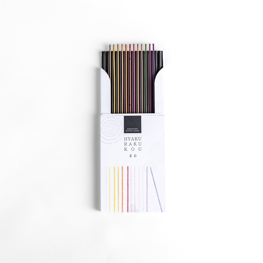 Incense set featuring a variety of vibrant sticks elegantly packaged in a sleek white box with subtle circular patterns, offering a diverse selection of rich and captivating aromas.