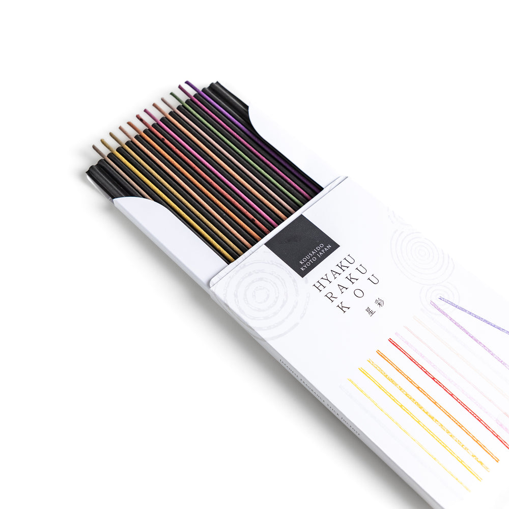 Incense set featuring a variety of vibrant sticks elegantly packaged in a sleek white box with subtle circular patterns, offering a diverse selection of rich and captivating aromas.