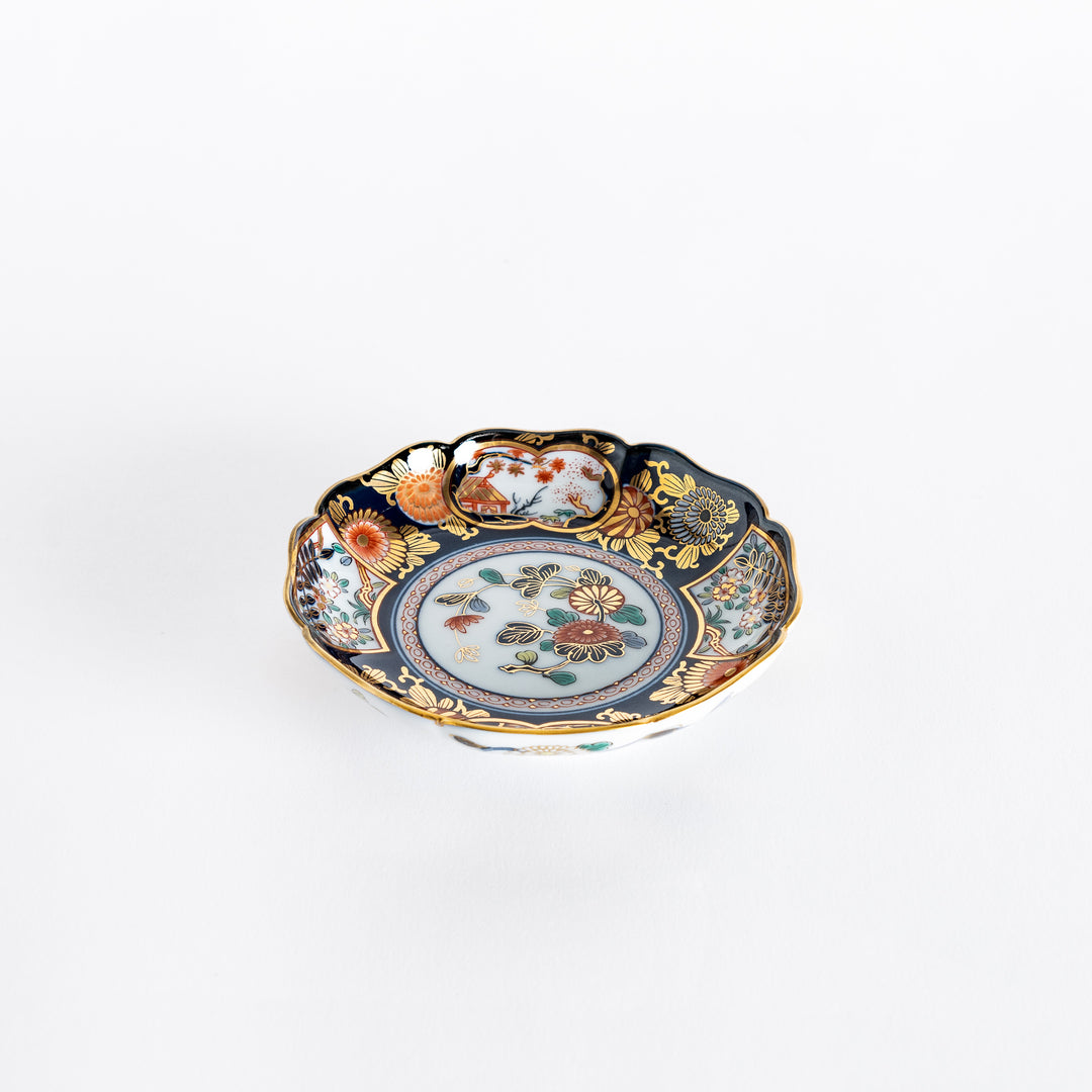 Slightly angled view of the Imperial Blossom sauce dish, highlighting the rich blue and gold border, and the colorful floral motifs in the center.