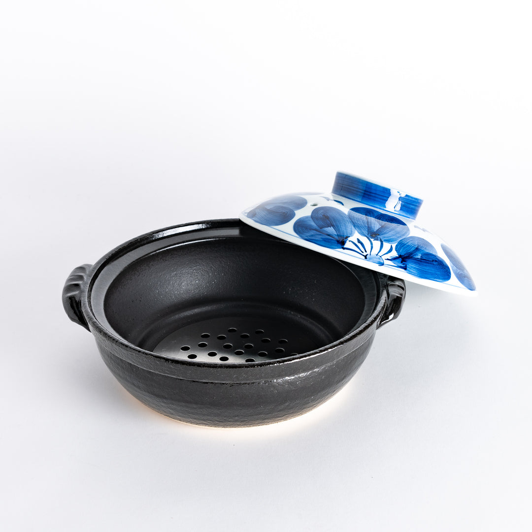 A 8-inch donabe with a vibrant blue floral pattern lid and black pot.