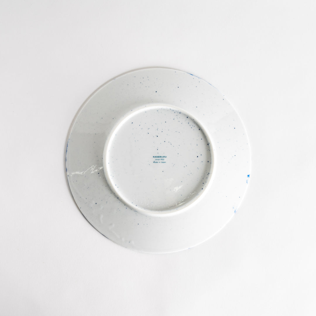 A round dinner plate with a blue bubble-like design on a white background.