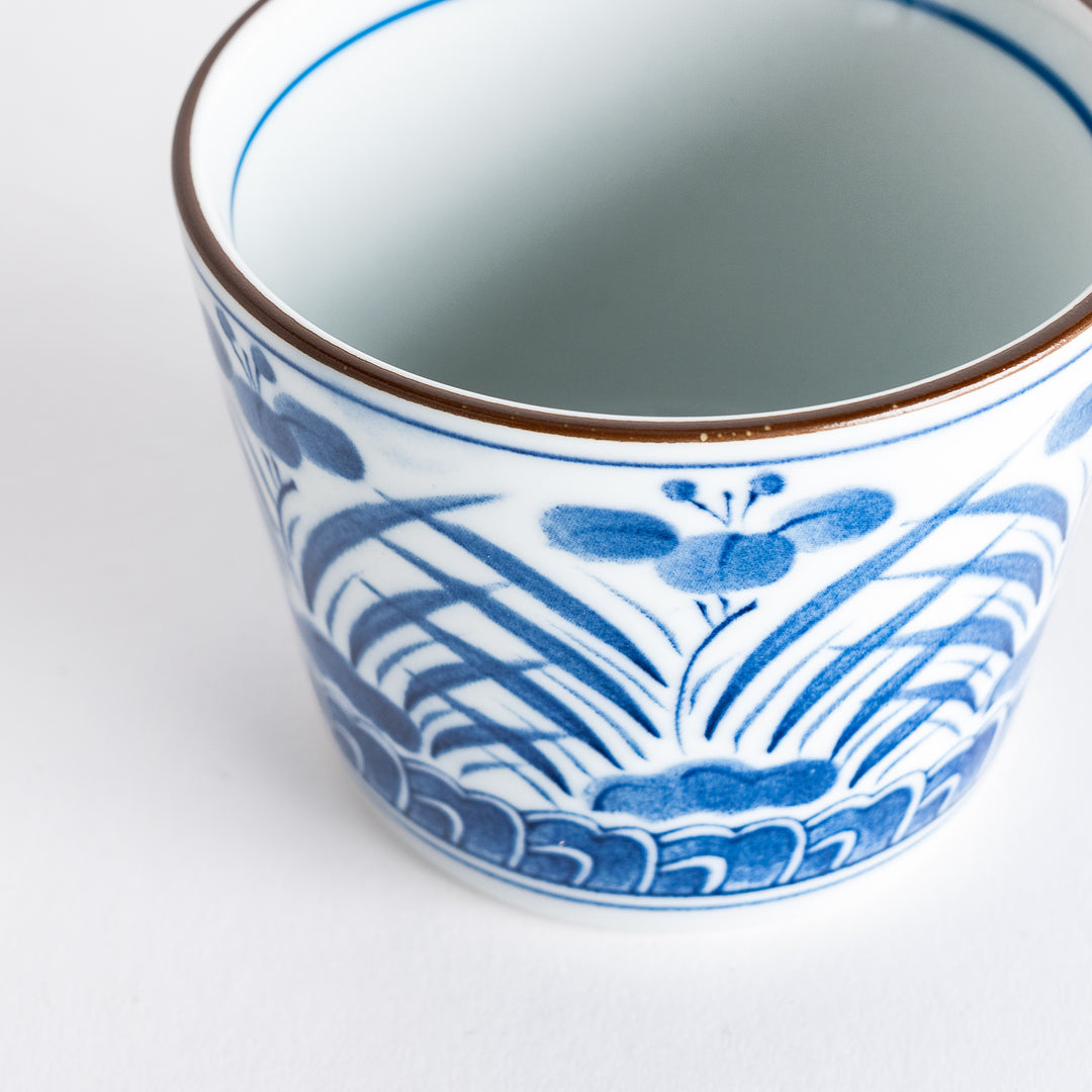 Close-up view of the interior of a ceramic bowl, highlighting the elegant floral pattern inspired by irises, adding a touch of sophistication.