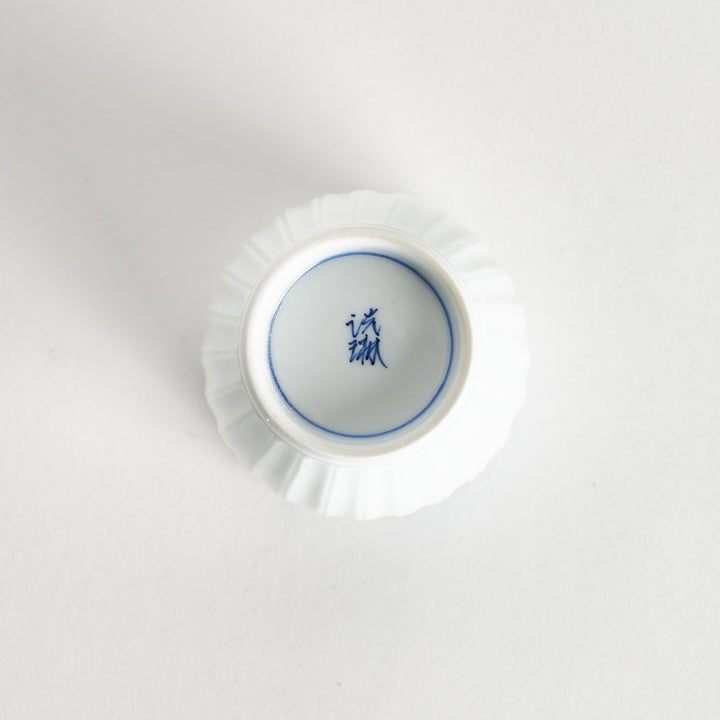 Bottom view of the Ivory Fluted Tea Cup, showcasing its base and the glossy ceramic finish.