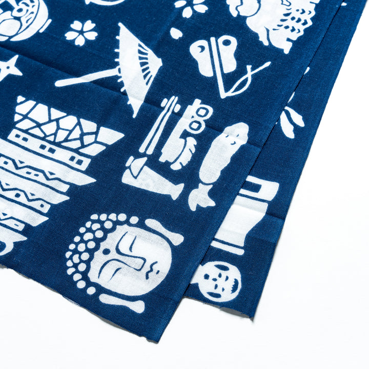 Close-up of the dark blue tenugui highlighting detailed white patterns of Mount Fuji and traditional icons.