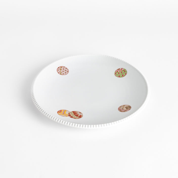 White dinner plate with vibrant temari ball designs, showcasing intricate details.