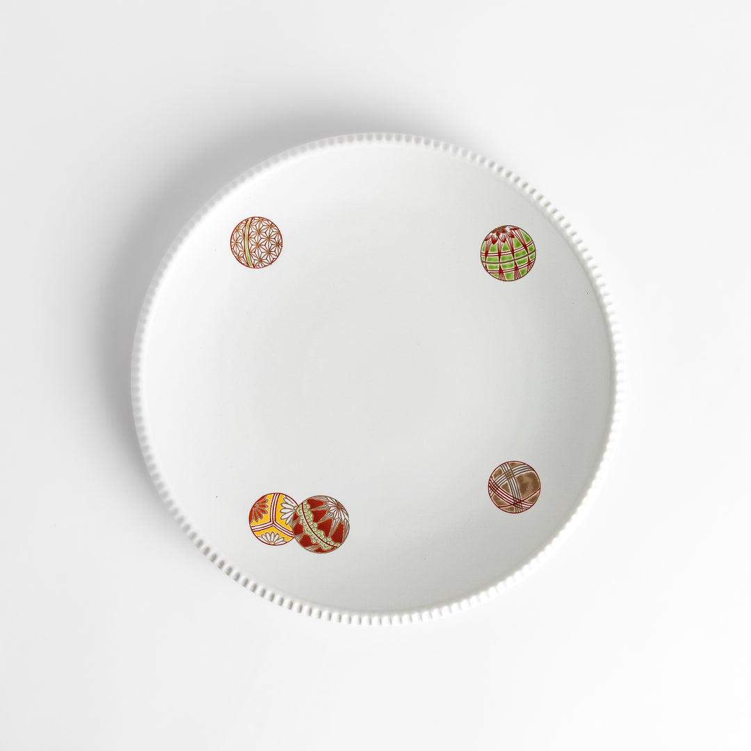 White dinner plate with vibrant temari ball designs, showcasing intricate details.