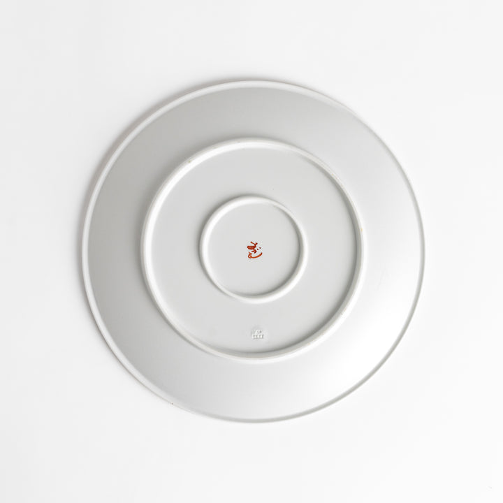 White dinner plate with vibrant temari ball designs, showcasing intricate details.