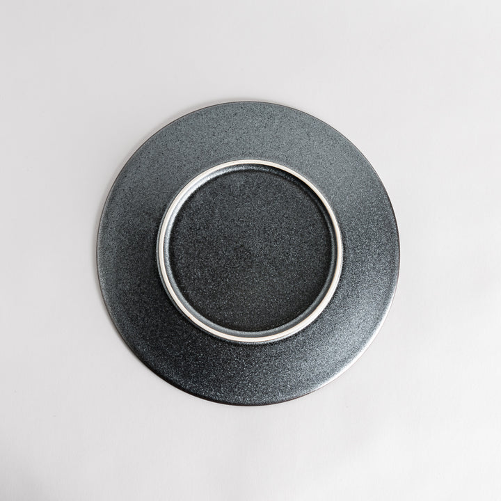 A round, matte black dinner plate with a smooth, understated design.