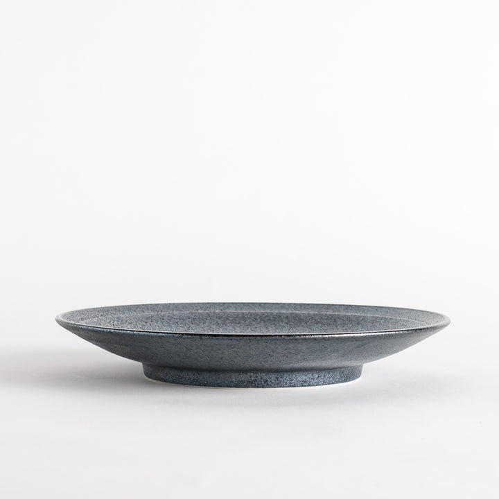 A round black salad plate with a subtle, rustic texture, ideal for modern table settings.