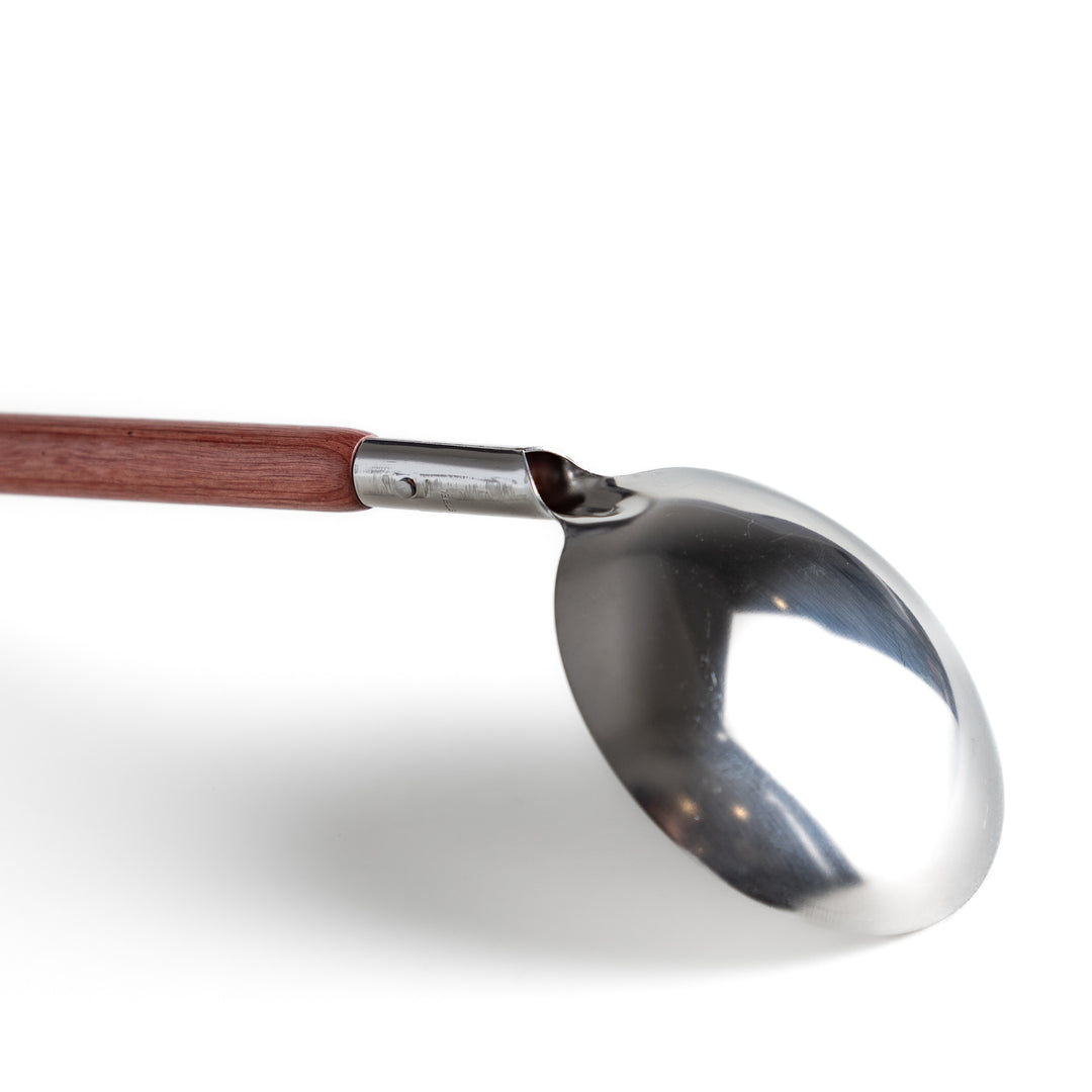 Durable wooden and stainless steel ladle, essential kitchenware for cooking.