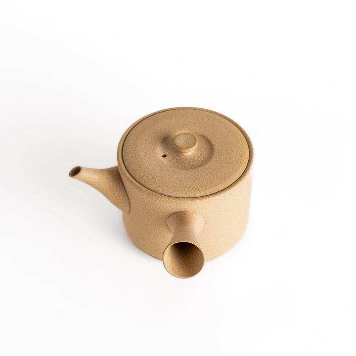 Beige teapot with the lid removed, revealing a smooth interior, presented in a clean top-down perspective.