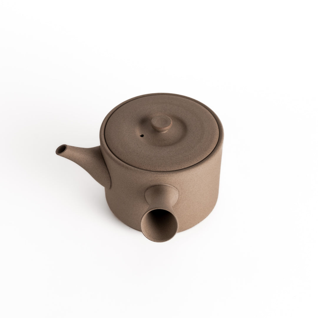 Slightly angled view of the gray teapot, highlighting its balanced shape and horizontal spout and handle.