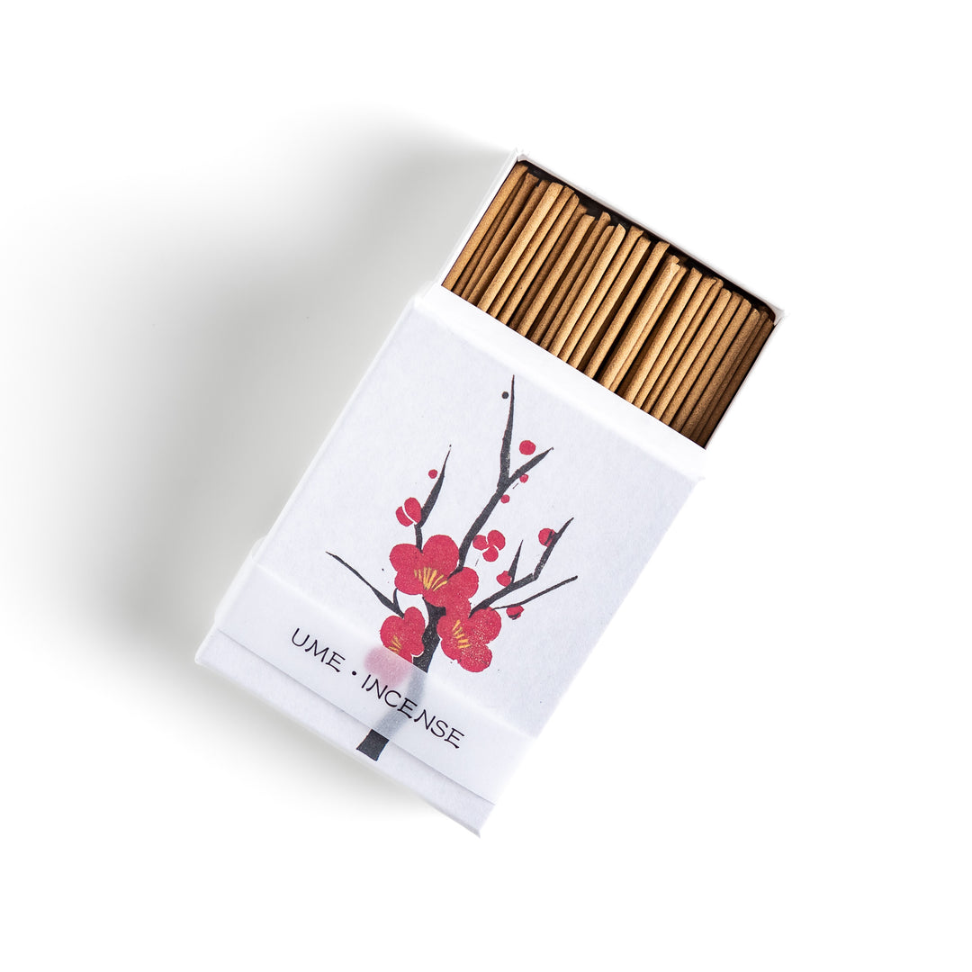 Incense featuring warm brown sticks in a box decorated with a delicate plum blossom illustration, offering a sweet and subtly floral fragrance inspired by Japanese ume flowers.