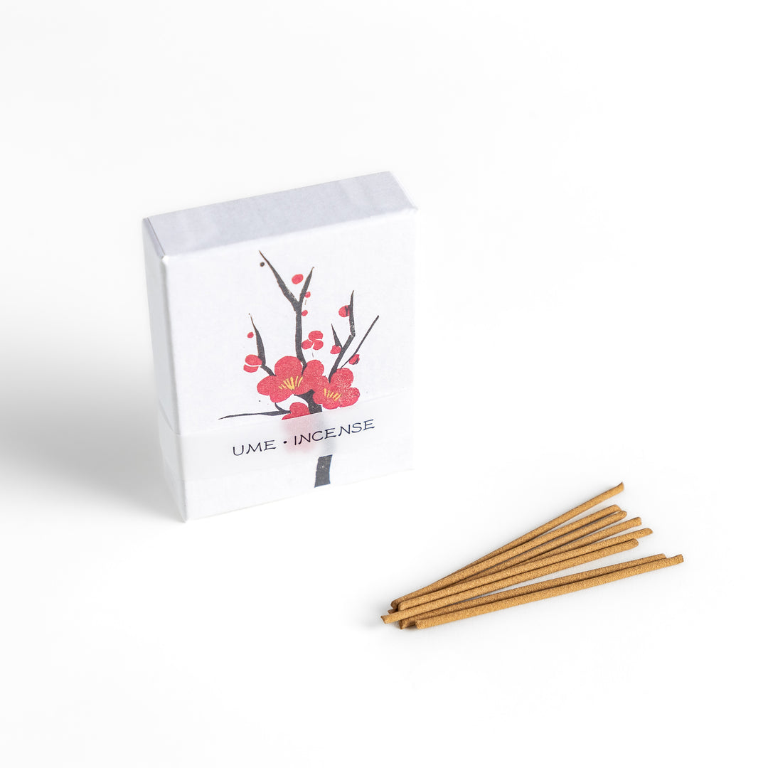 Incense featuring warm brown sticks in a box decorated with a delicate plum blossom illustration, offering a sweet and subtly floral fragrance inspired by Japanese ume flowers.