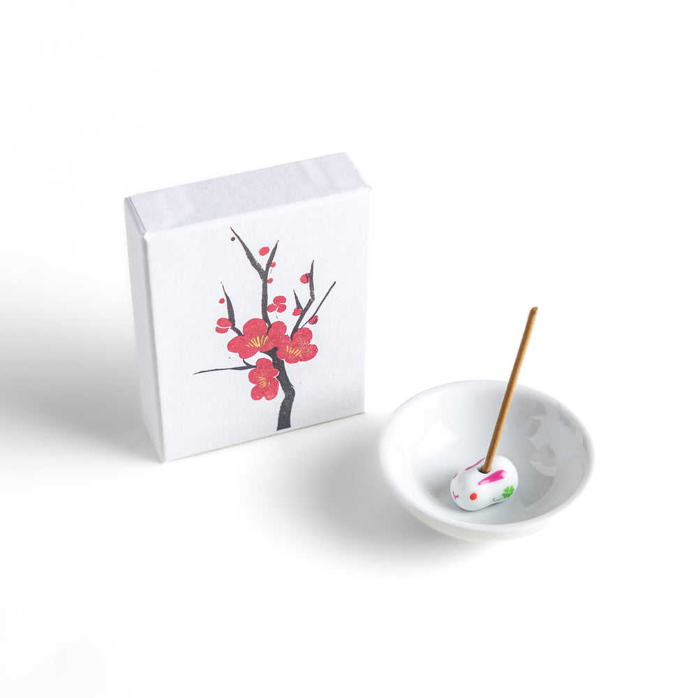 Incense featuring warm brown sticks in a box decorated with a delicate plum blossom illustration, offering a sweet and subtly floral fragrance inspired by Japanese ume flowers.