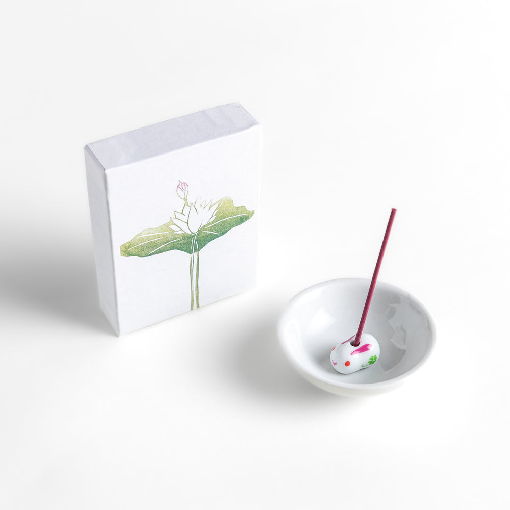 Incense featuring soft pink sticks in a box adorned with a delicate lotus flower design, offering a gentle and floral fragrance for a serene atmosphere.